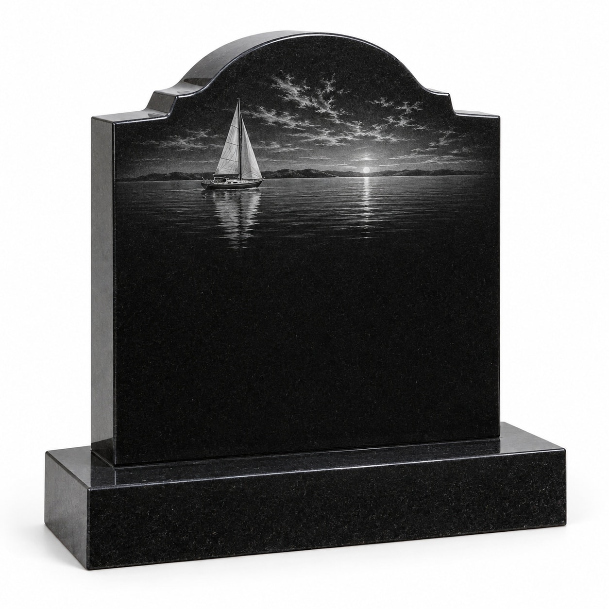 Black granite shouldered memorial with etched sailboat at sunset